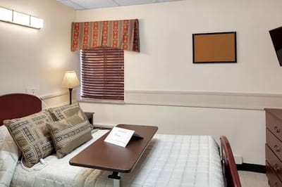 Private resident room with a bed and window