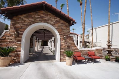 Outdoor entrance of the senior living facility with landscaping.