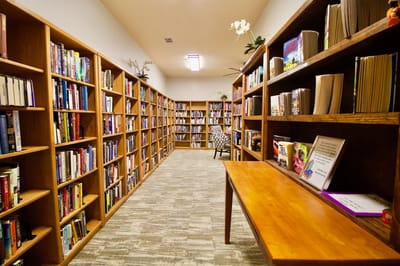 Interior view of a library with wooden shelves filled with books