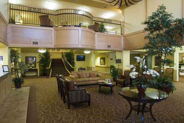Interior view of a cozy facility lobby with seating and plants