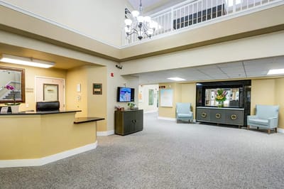 Bright lobby area with a reception desk and seating
