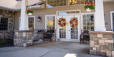 Exterior entrance with floral decorations and seating