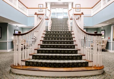 Elegant stairway in a senior living facility lobby