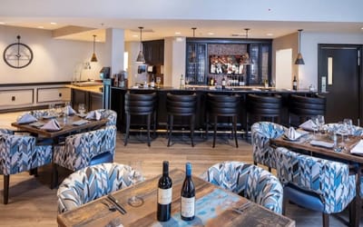 Inside view of a stylish dining room with wine bottles