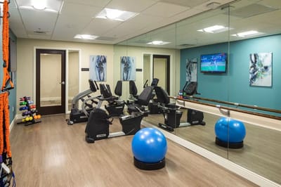 Fitness room with equipment and a large mirror