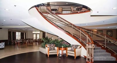 Bright lobby area with a grand staircase