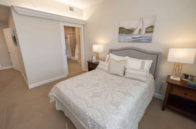 Well-decorated private resident room with a bed and painting