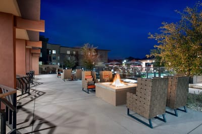 Outdoor seating area with a fire pit at night