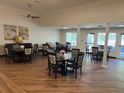 Bright dining area with tables and floral decorations