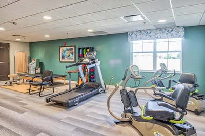 Interior exercise room with equipment and mats