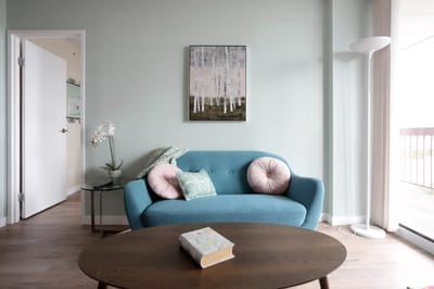 Cozy living room with a blue sofa and art on the wall