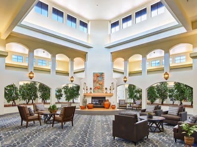Spacious lobby area with comfortable seating and greenery