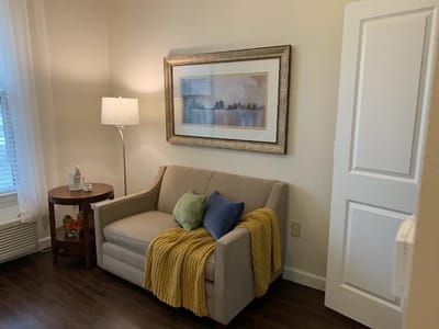 Cozy interior of a resident's room with a couch and decorative items
