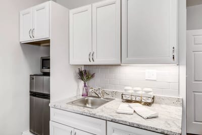 Kitchen area with white cabinets and counter space