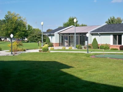 Exterior view of Riverside Lodge with landscaped grounds
