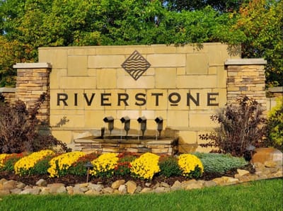 Outdoor entrance sign with flowers and fountain