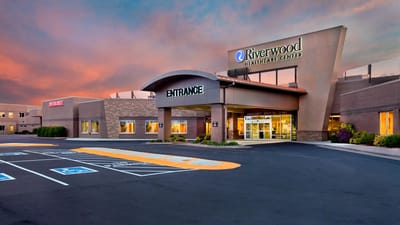 Front entrance of Riverwood Health Care Center with sunset