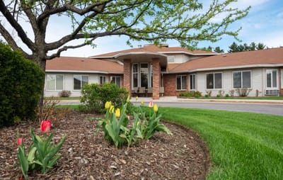 Exterior view of a nursing home with garden flowers