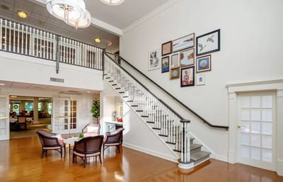 Interior view of a common area with staircase and art display