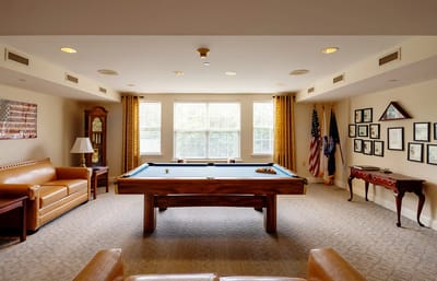 Bright common area with a pool table and seating