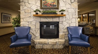 Cozy common area with stone fireplace and seating