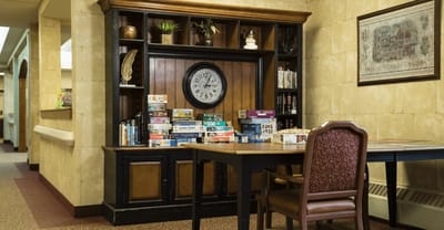 Common area with a clock and games on shelves