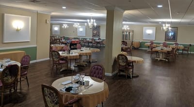 Dining area with tables and chairs arranged for meals