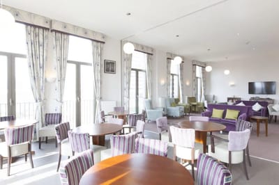 Bright common area with seating and tables