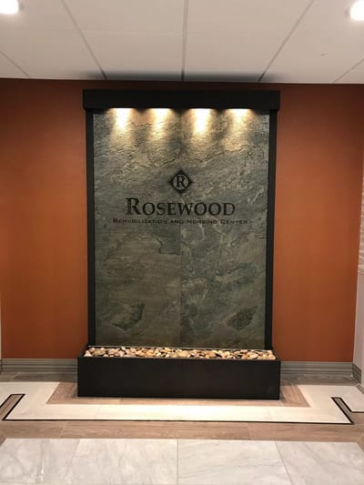 Interior stone wall feature with facility name