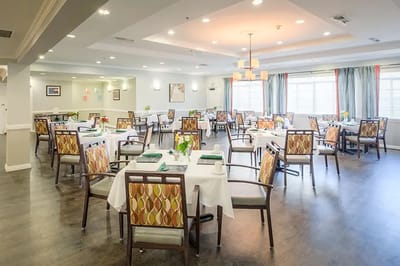 Bright dining room with tables set for residents