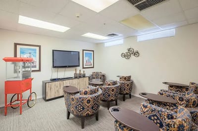 Cozy common area with comfortable seating and a popcorn machine