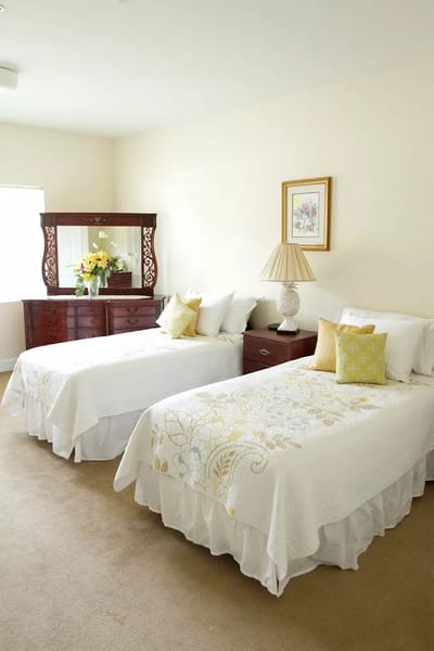 Cozy resident room with twin beds and decor