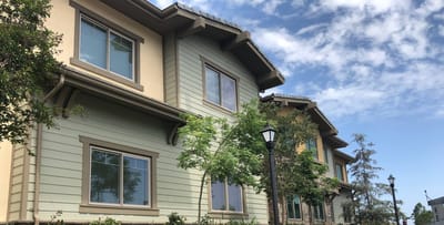 Exterior view of a senior living building with trees