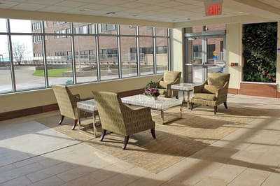 Bright common area with seating and large windows