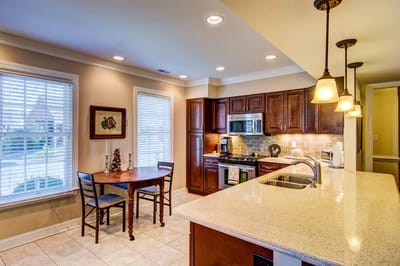 Bright kitchen area with dining table and modern appliances