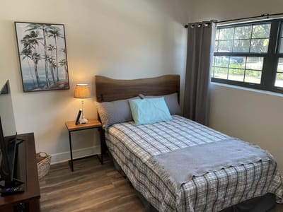 Cozy interior of a resident’s room with a bed and artwork