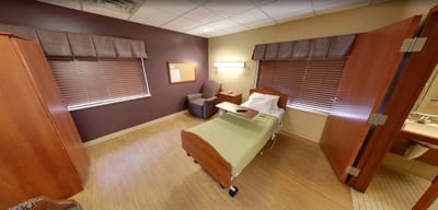 Private resident room with medical bed and seating area