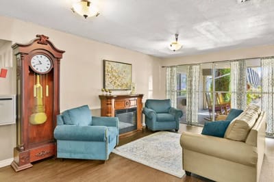 Bright common area with comfortable seating and clock