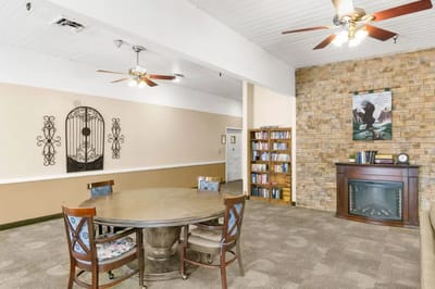 Common area with a round table and bookshelves