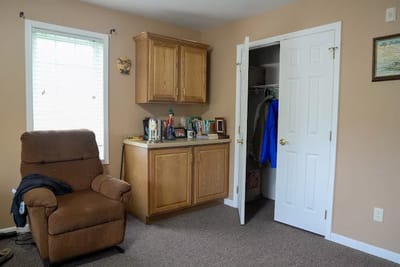 Cozy interior of a resident's room with a recliner and closet
