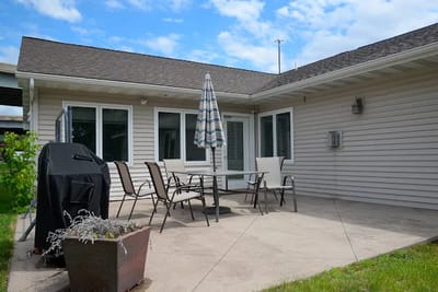 Outdoor patio area with seating and grill