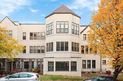 Exterior view of St Anthony Park Home building surrounded by trees