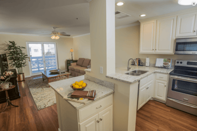 Modern living room with kitchen area in a senior living facility
