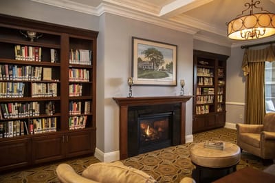 Cozy library area with bookshelves and a fireplace