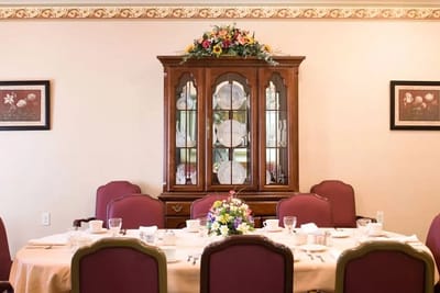 Dining room set up for a meal with flowers