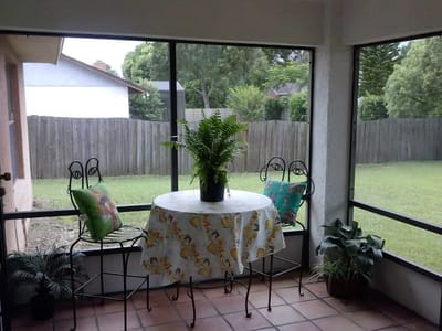Cozy sunroom with seating and a view of the garden