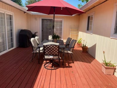 Outdoor patio area with seating and umbrella