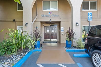 Entrance to Serra Highlands Senior Living with landscaping
