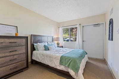 A well-furnished resident bedroom with natural light