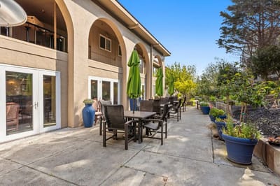 Outdoor seating area with tables and plants